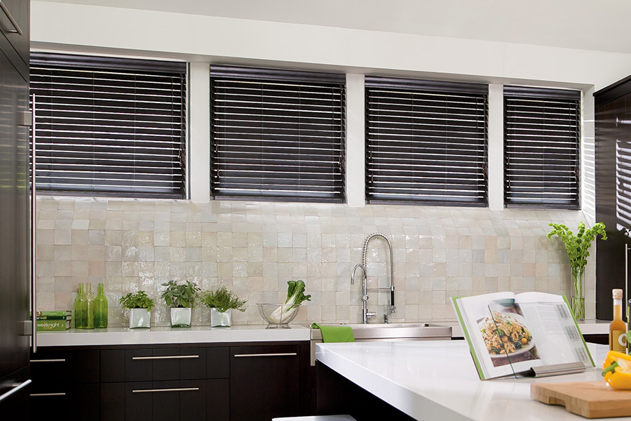 Choose custom Polywood faux wood blinds for your kitchen in Denver. Special shaped faux wood blinds in several windows above a sink.