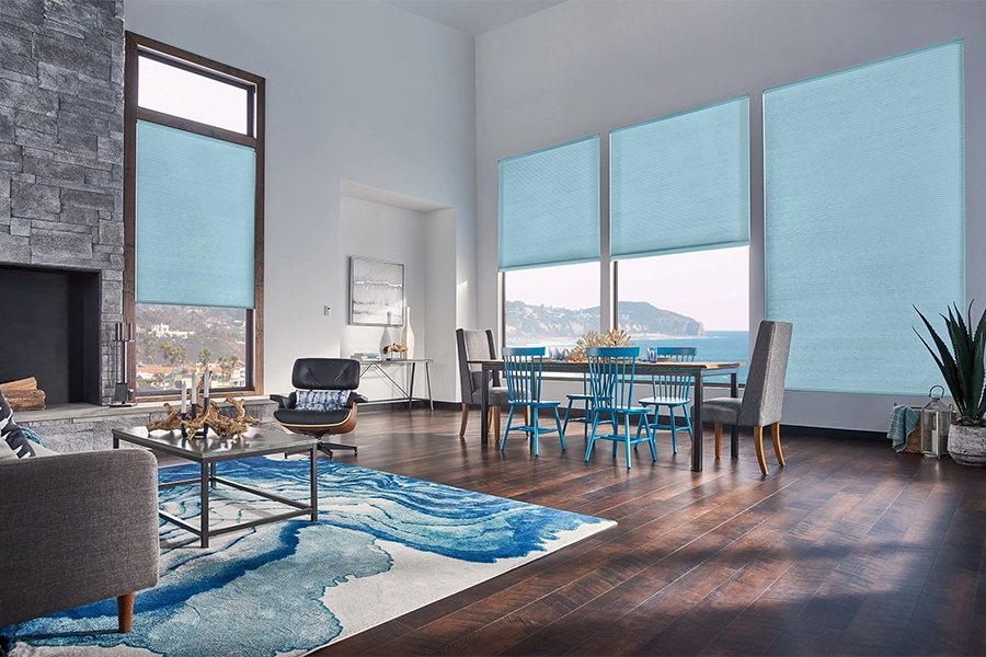 Smart motorized window shades are perfect on tall windows in your Denver home. Blue motorized shades on tall living room windows
